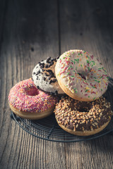 Delicious and sweet donuts ready to eat on metal grate