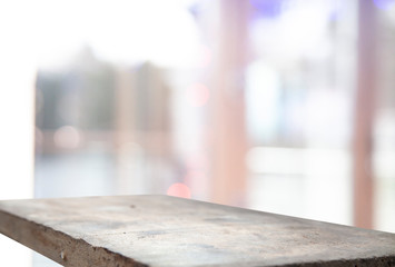 Blurry white tones cafe restaurant club background with wooden table top for mounting your product.