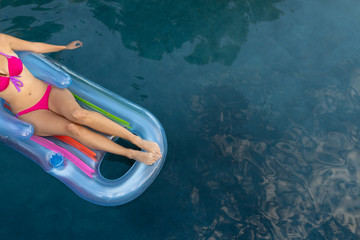 Young woman relaxing in the swimming pool