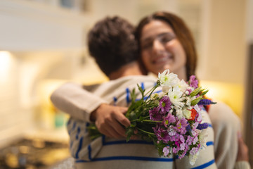 Young man giving a bouquet flower to young woman