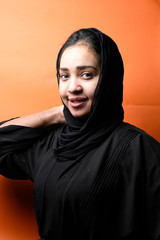 Portrait of arabic woman with traditional abaya dress in a studio