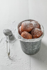 Closeup of sweet donuts balls with powdered sugar