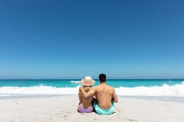 Young couple sitting at the beach