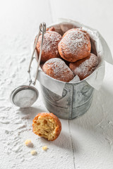 Tasty and homemade mini doughnuts on white table