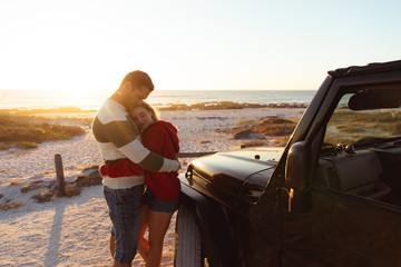 Couple with car in love at the beach