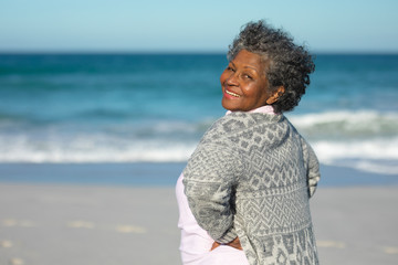 Old woman smiling at the beach