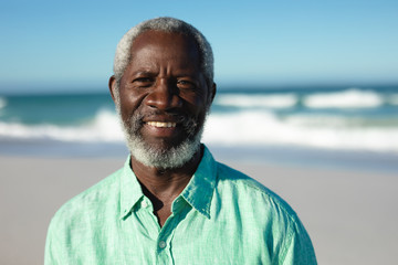 Old man smiling at the beach