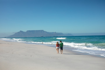 Young couple walking at the beach