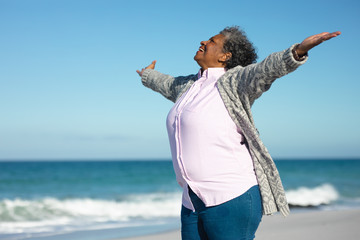 Old woman smiling at the beach