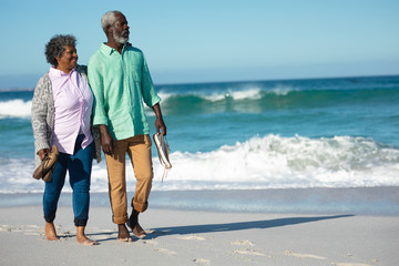 Old couple walking at the beach