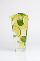 Cocktail with mint, lime and crushed ice on a white background