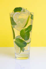Cocktail with mint, lime and crushed ice on a white background