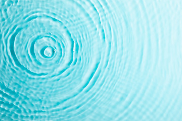 Fototapeta na wymiar Water background. Blue water texture, surface of blue swimming pool. Spa concept background. Flat lay, top view, copy space