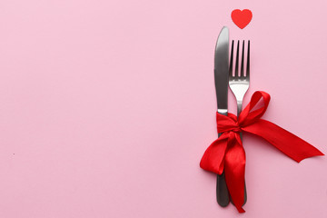 Fork and knife, concept of a romantic dinner on Valentine's Day, space for text