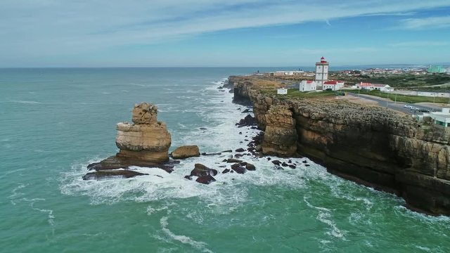 Aerial view of lighthouse on Cabo Carvoeiro and Atlantic ocean in Portugal, 4k