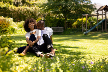 Happy young couple relaxing in the garden