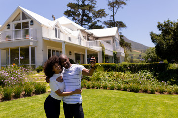 Happy young couple taking selfie in the garden