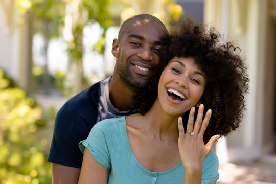 Happy Young Couple With Woman Showing Her Wedding Ring