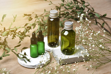 Cosmetic bottle containers packaging with green herbal leaves, Blank label for organic branding...