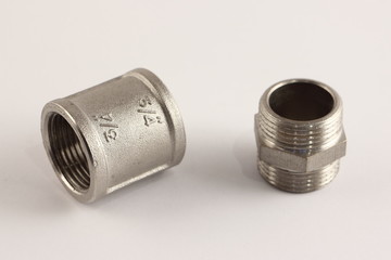 3/4" thread coupling sleeve and G 3/4" threaded pipe connectors, close up plumbing fixtures on white background