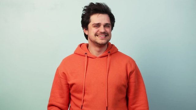 consonant guy in orange hoodie on blue background