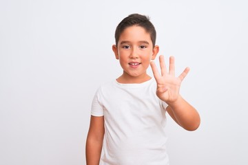 Beautiful kid boy wearing casual t-shirt standing over isolated white background showing and pointing up with fingers number four while smiling confident and happy.
