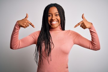 Young african american woman standing casual and cool over white isolated background looking...