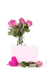Beautiful pink roses in a bottle on a white background. Isolate Concept Valentine's Day, Mother's Day. Holiday gift.
