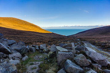 Mourne Mountains are the highest and most dramatic mountain range in Northern Ireland. View from valley near Slieve Donard mountain peak on Irish Sea