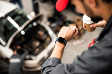 Man in a cap checking the time
