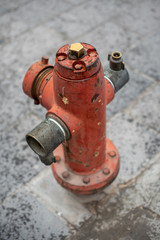 A vintage and isolated red fire hydrant on the sidewalk, shot from the top