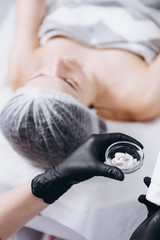 01.02.2020 Kyiv, Ukraine: portrait of a young female client who came to the cosmetologist to do a spa treatment on the face (massage, peeling and mask).Beauty and self care concept