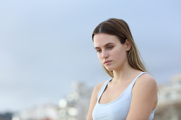 Sad woman looking down in the street