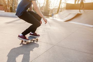 Unrecognizable skateboarder on his board. Photo was taken in backlight