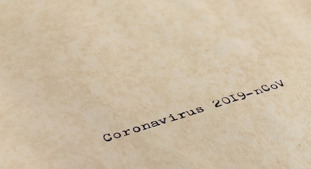 Coronavirus 2019-nCoV written with typewriter on old yellowish paper taken with narrow focus