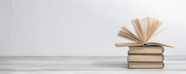 Open book, hardback books on wooden table. Back to school. Copy space