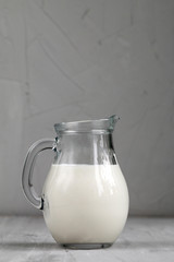 Kefir in glass jug isolated on grey background, healthy food and  diet concept, empty space for text
