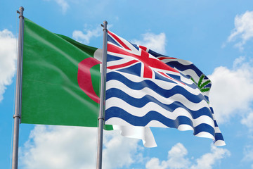 British Indian Ocean Territory and Algeria flags waving in the wind against white cloudy blue sky together. Diplomacy concept, international relations.