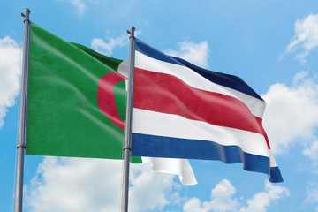 Costa Rica and Algeria flags waving in the wind against white cloudy blue sky together. Diplomacy concept, international relations.