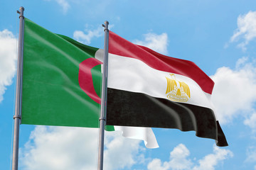 Egypt and Algeria flags waving in the wind against white cloudy blue sky together. Diplomacy concept, international relations.