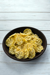 Mini corn bread with salt and olive herbs in a clay plate on a white board. Corn cakes. Healthy cereal snacks. Proper nutrition.