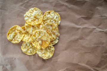Mini corn bread with salt and Provence herbs on craft paper. Corn cakes. Healthy cereal snacks. Proper nutrition.