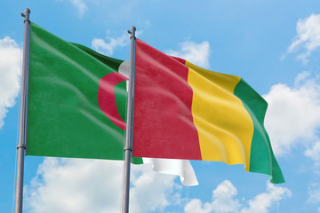 Guinea and Algeria flags waving in the wind against white cloudy blue sky together. Diplomacy concept, international relations.