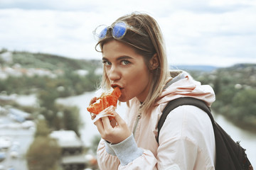 Woman eating a papaya fruit outdoor.