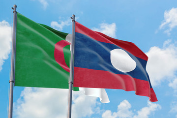 Laos and Algeria flags waving in the wind against white cloudy blue sky together. Diplomacy concept, international relations.