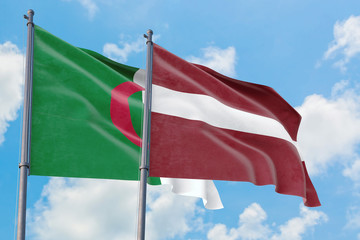 Latvia and Algeria flags waving in the wind against white cloudy blue sky together. Diplomacy concept, international relations.