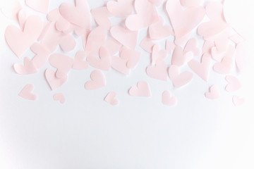 Cute pink pastel hearts border on white paper  background with copy space. Flat lay. Happy valentines day. Pink paper heart cutouts on white backdrop, gentle image, greeting card.