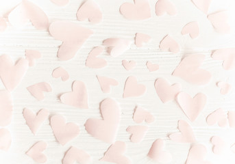 Happy valentines day. Cute pink pastel hearts on white wooden background. Flat lay. Pink paper heart cutouts on white backdrop, gentle image, greeting card.