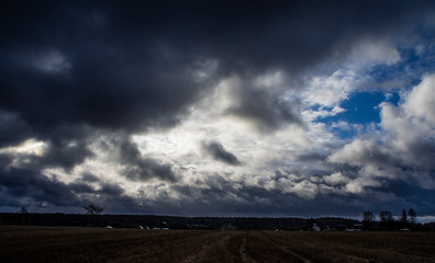 Thunderstorm contrasting clouds in spring in the field