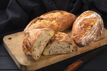 Fresh bread ready to be used. Fresh homemade baked bread on the board and sliced bread. bread - freshly baked tasty pastries, menu concept. food background.